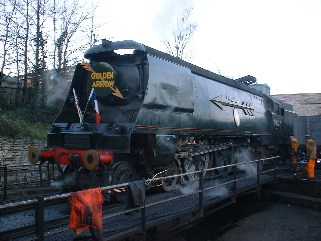 Merchant Nave Pacific class steam locomotive being coaled and watered at Swanage railway shed.